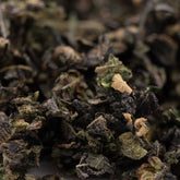 Close-up of dry dark green and brown Purple Wedding Cake indoor trim with lighter THCA trim